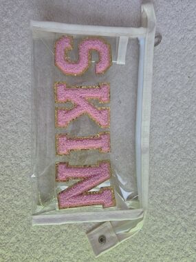 Clear Cosmetic Bag with Pink 'SKIN' Lettering